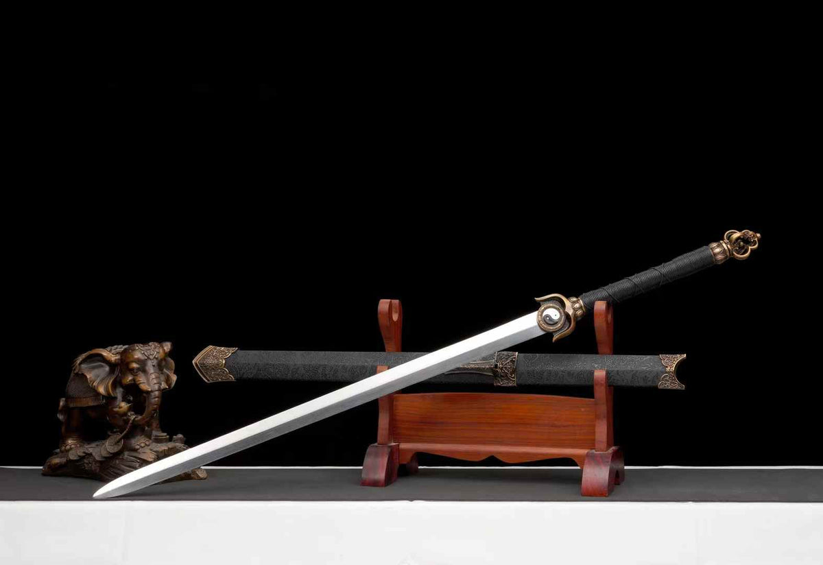 Angled full view of Chenguang Tai Chi Jian and matching black scabbard; wooden stand and decorative statue not included