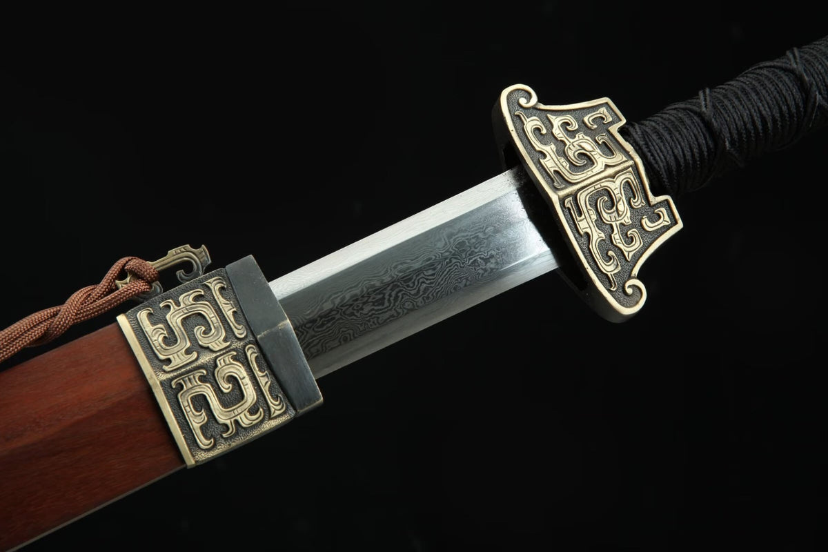 Hanwang Jian partially drawn to show the patterned steel blade, carved brass guard and scabbard throat