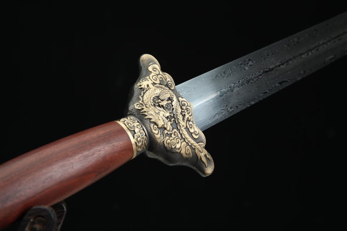 Reverse close-up of the Longyao Jian brass dragon guard and patterned blade