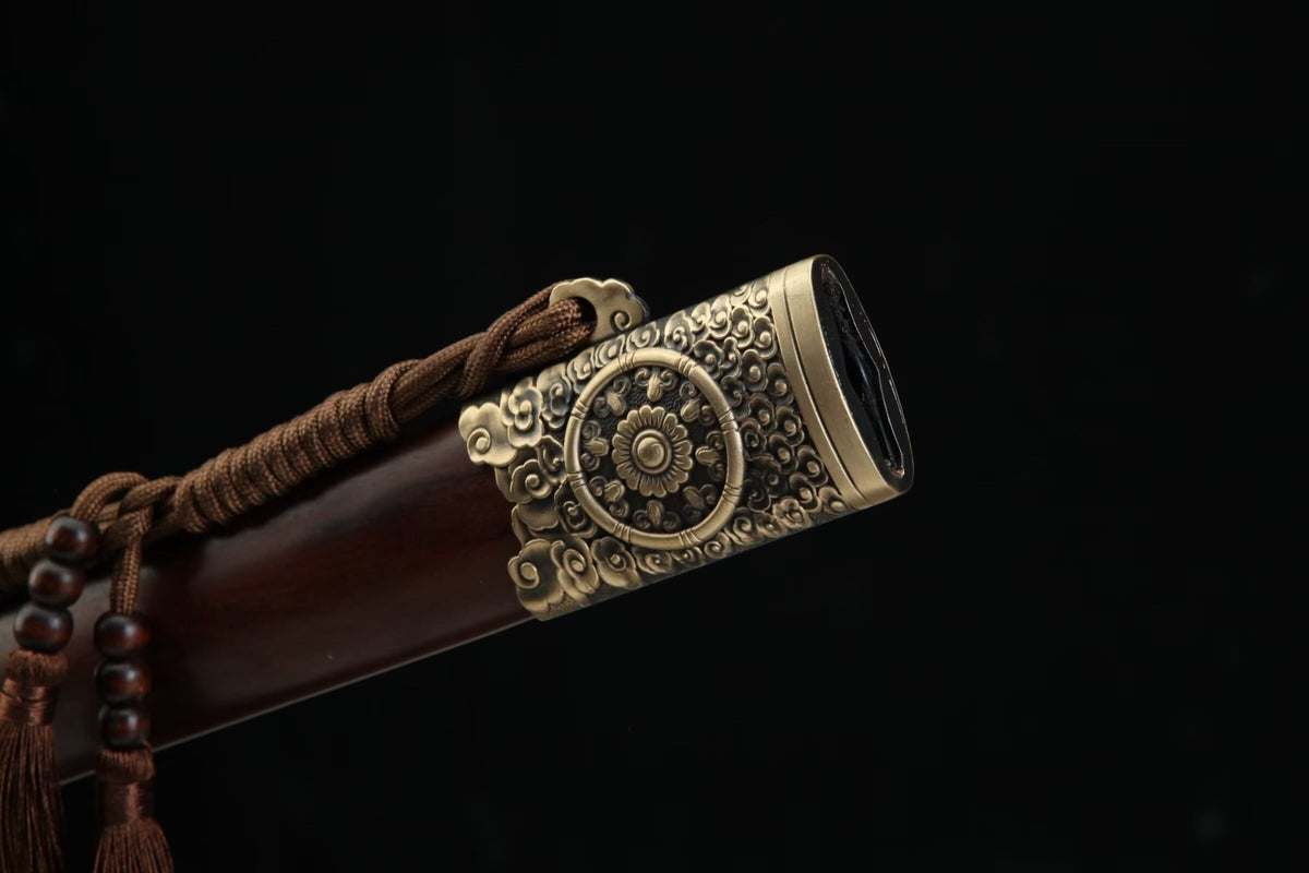 Close-up of the ornate brass mouth fitting and brown cord on the Longyao Jian wooden scabbard