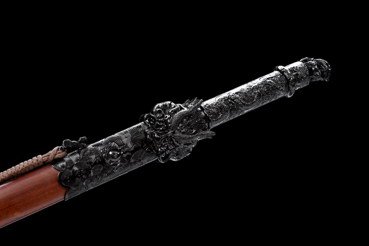 Dark dragon-decorated handle and sculpted guard of the Black Dragon Jian beside the wooden scabbard