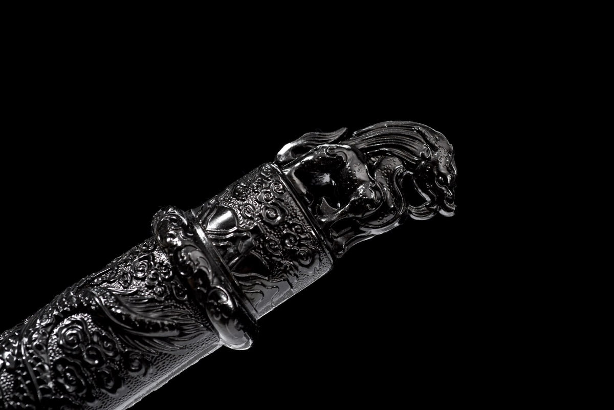 Close-up of the ornate dark pommel and dragon relief on the Black Dragon Jian handle