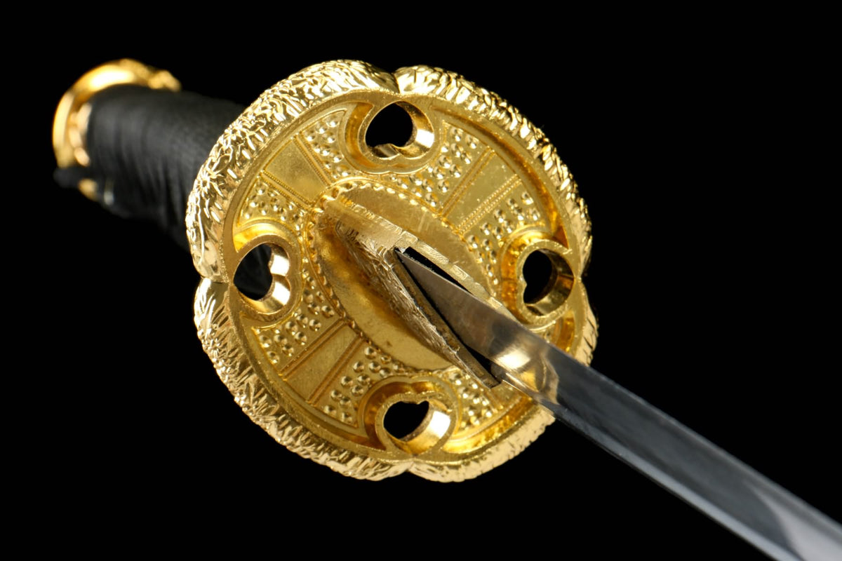 Round gold-tone Tachi guard with pierced openings and relief decoration