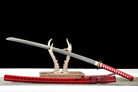 Feather-pattern katana displayed with red lacquer wood saya
