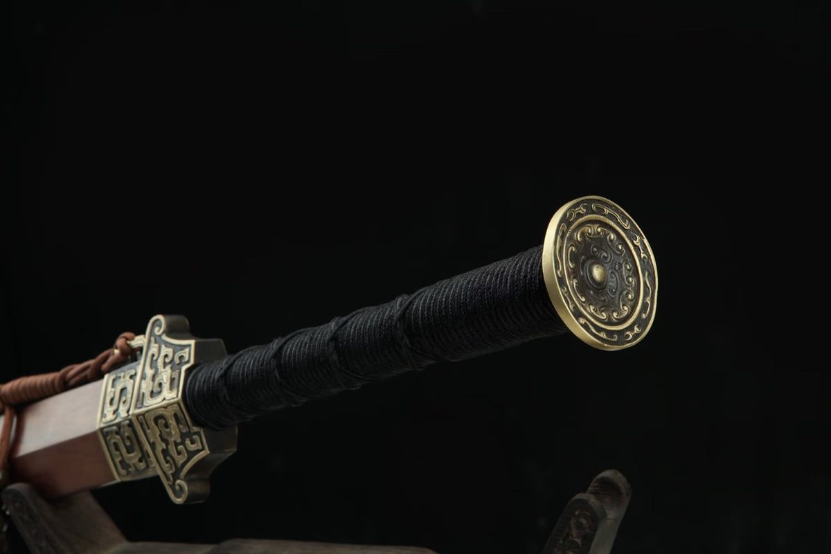 Round decorated brass pommel and black cord wrapping on the Hanwang Jian handle