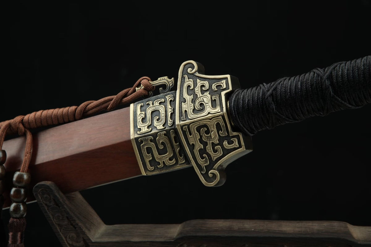 Hanwang Jian sheathed, showing the carved brass guard, matching throat fitting and black cord handle