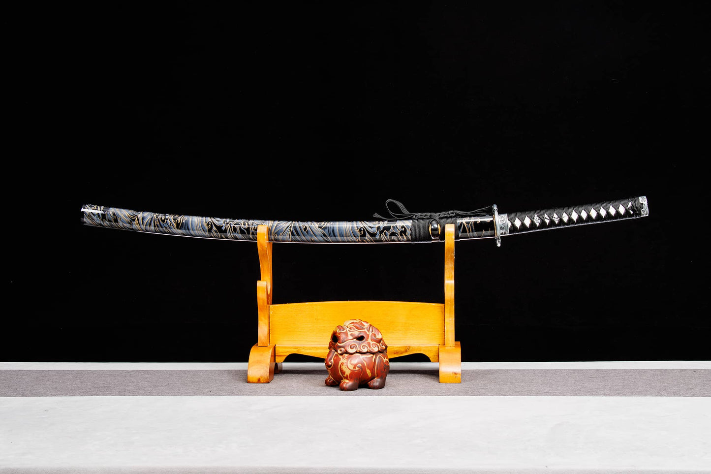 katana sword with lacquered wood saya on display stand