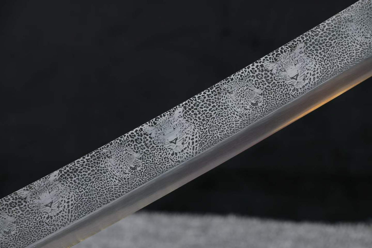 Close-up of the decorative leopard spots and leopard-face motifs across the Kangxi Dao blade