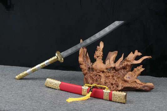 Leopard-pattern Kangxi Dao with a long ornate handle and red scabbard beside a decorative wood stand; stand not included
