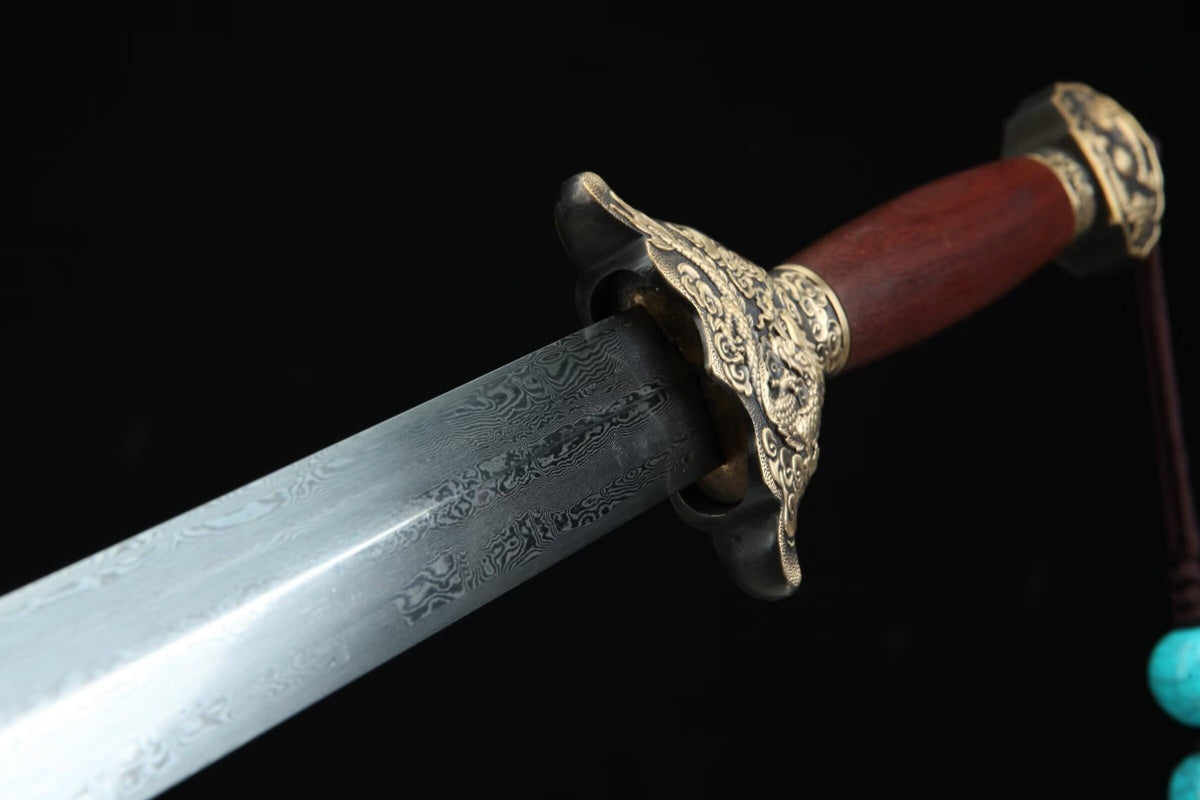Patterned Longyao Jian blade beside the carved brass dragon guard and reddish-brown handle