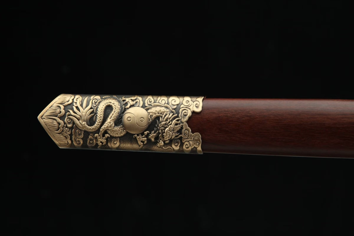 Carved brass dragon and Yin-Yang design on the end fitting of the Longyao Jian scabbard