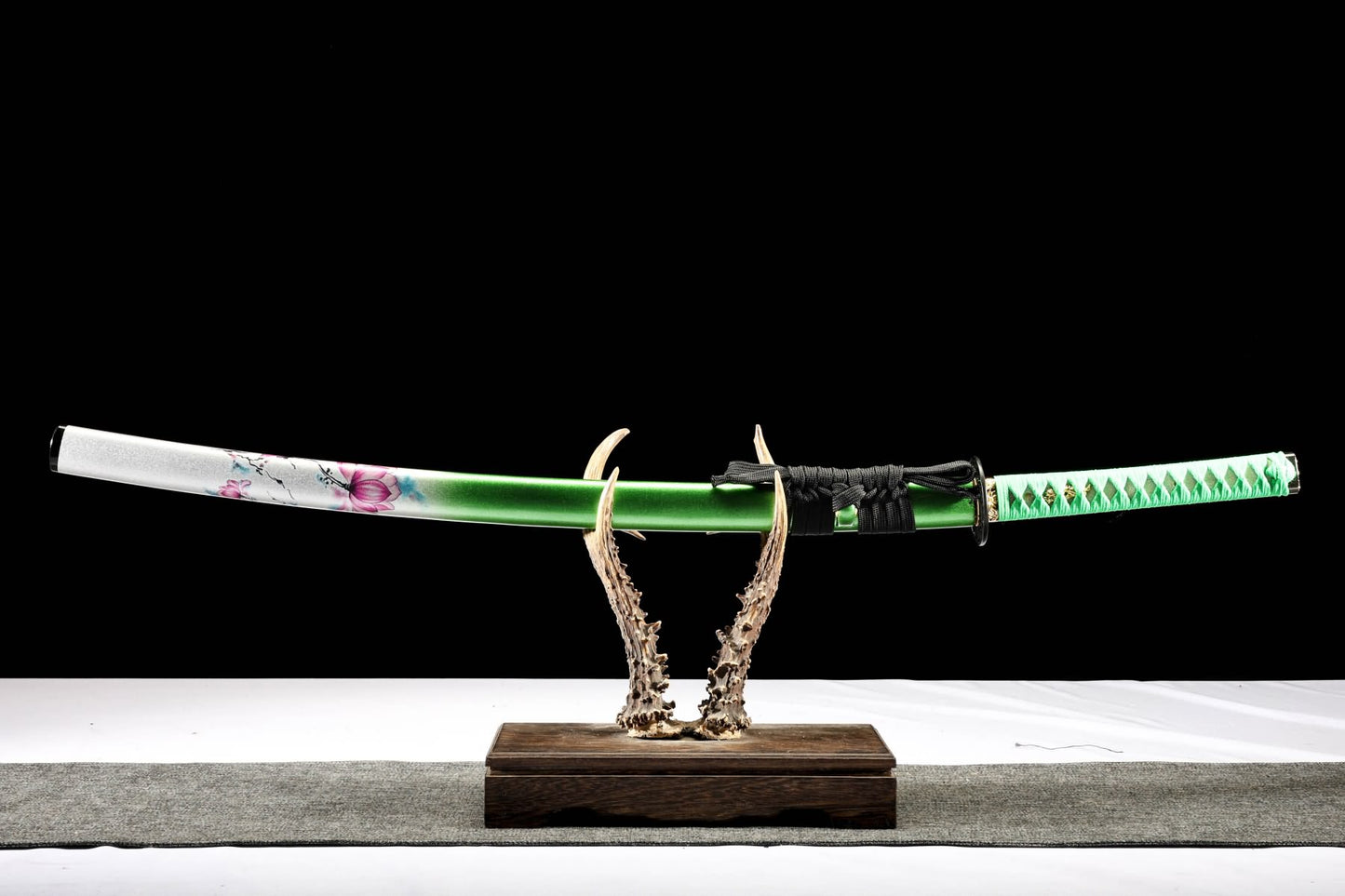 Sheathed lotus katana with green handle wrap and sageo