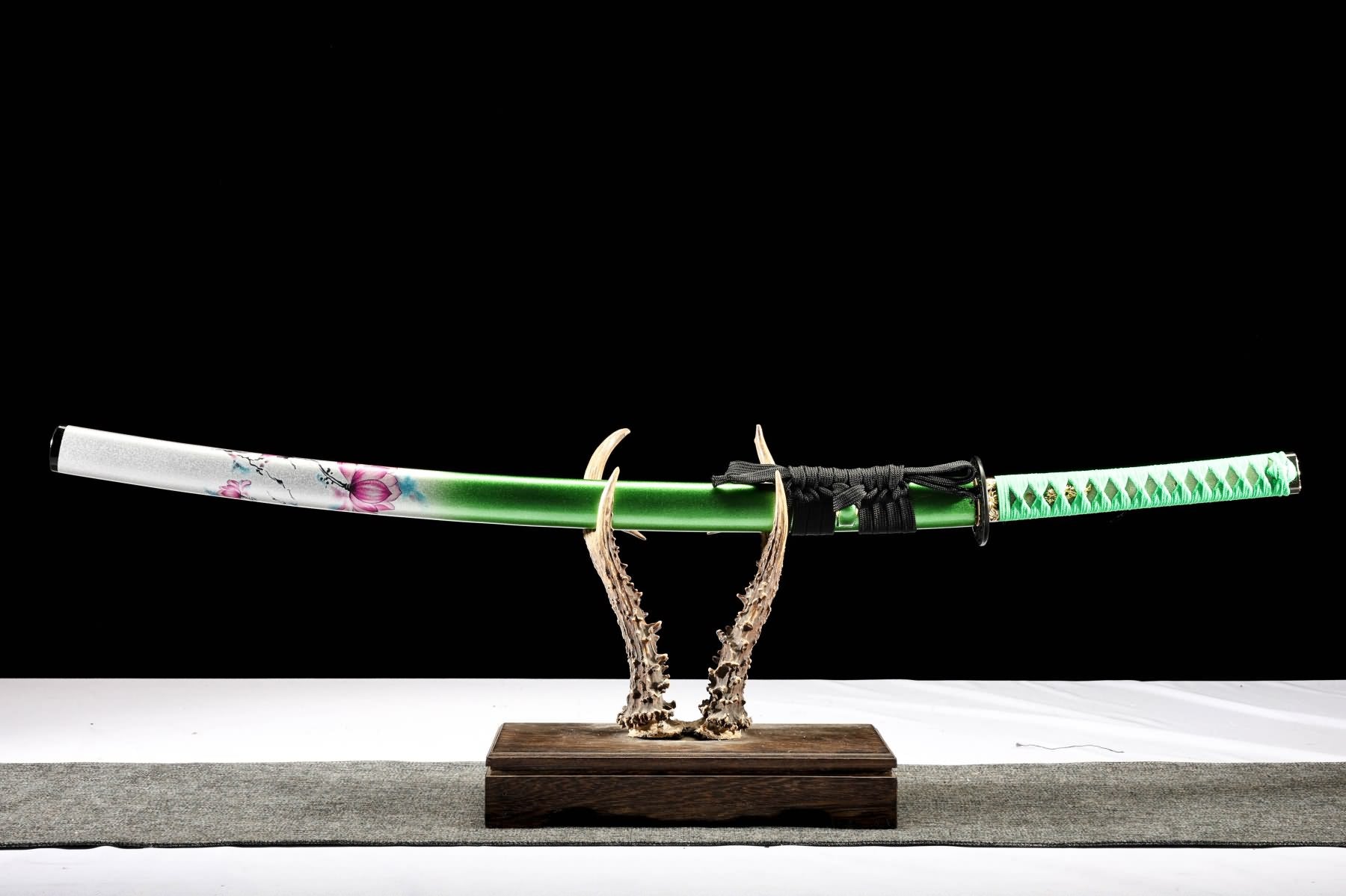 Sheathed lotus katana with green handle wrap and sageo