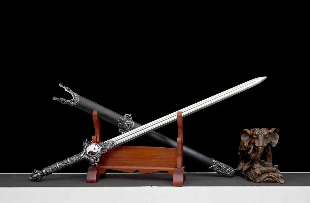 Reverse angled view of Qingfeng Jian with its blade across the dark scabbard; display props not included