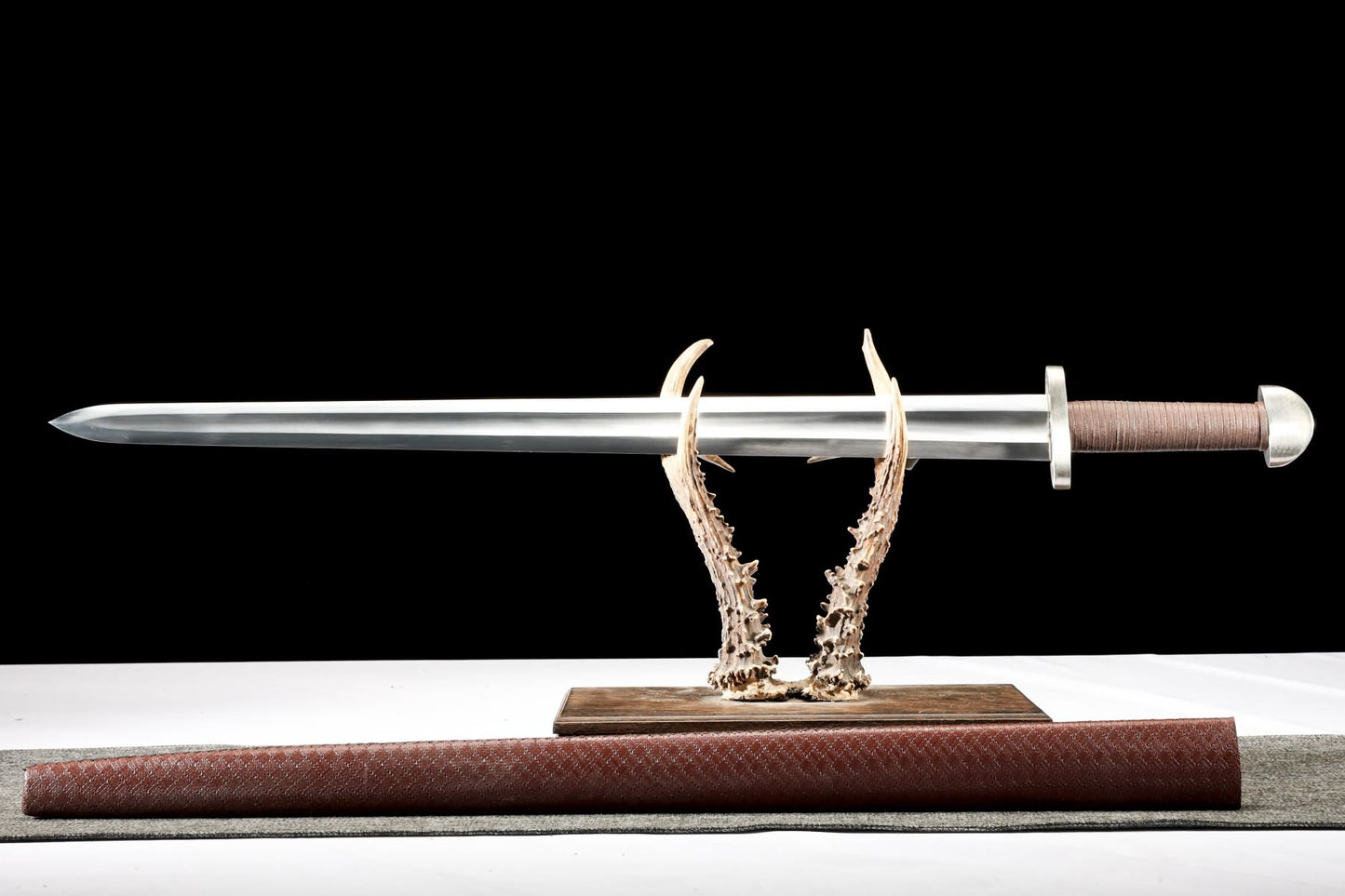 Full-length Viking sword displayed above matching scabbard