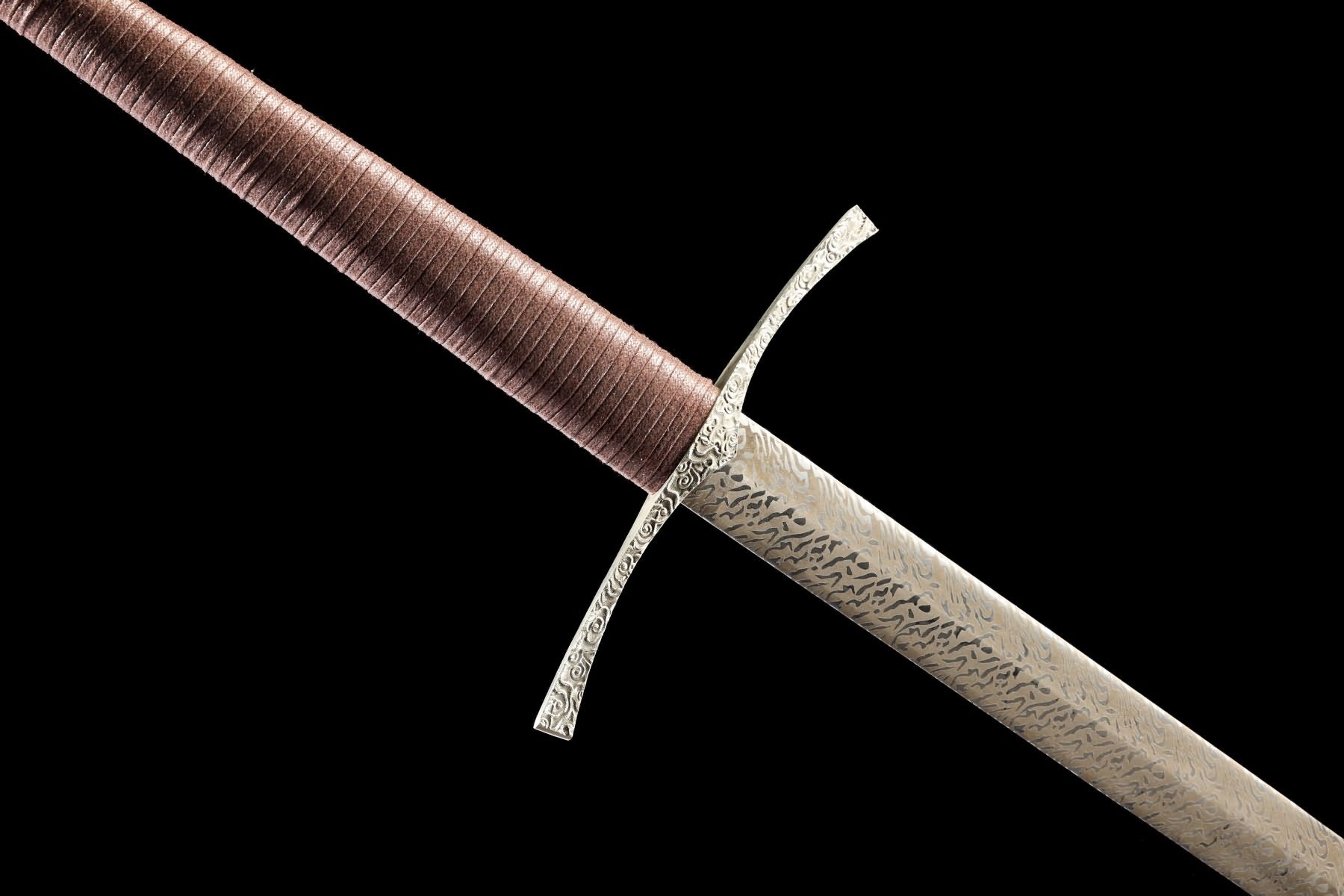 Close-up of cloud-pattern blade surface and decorated stainless-steel crossguard