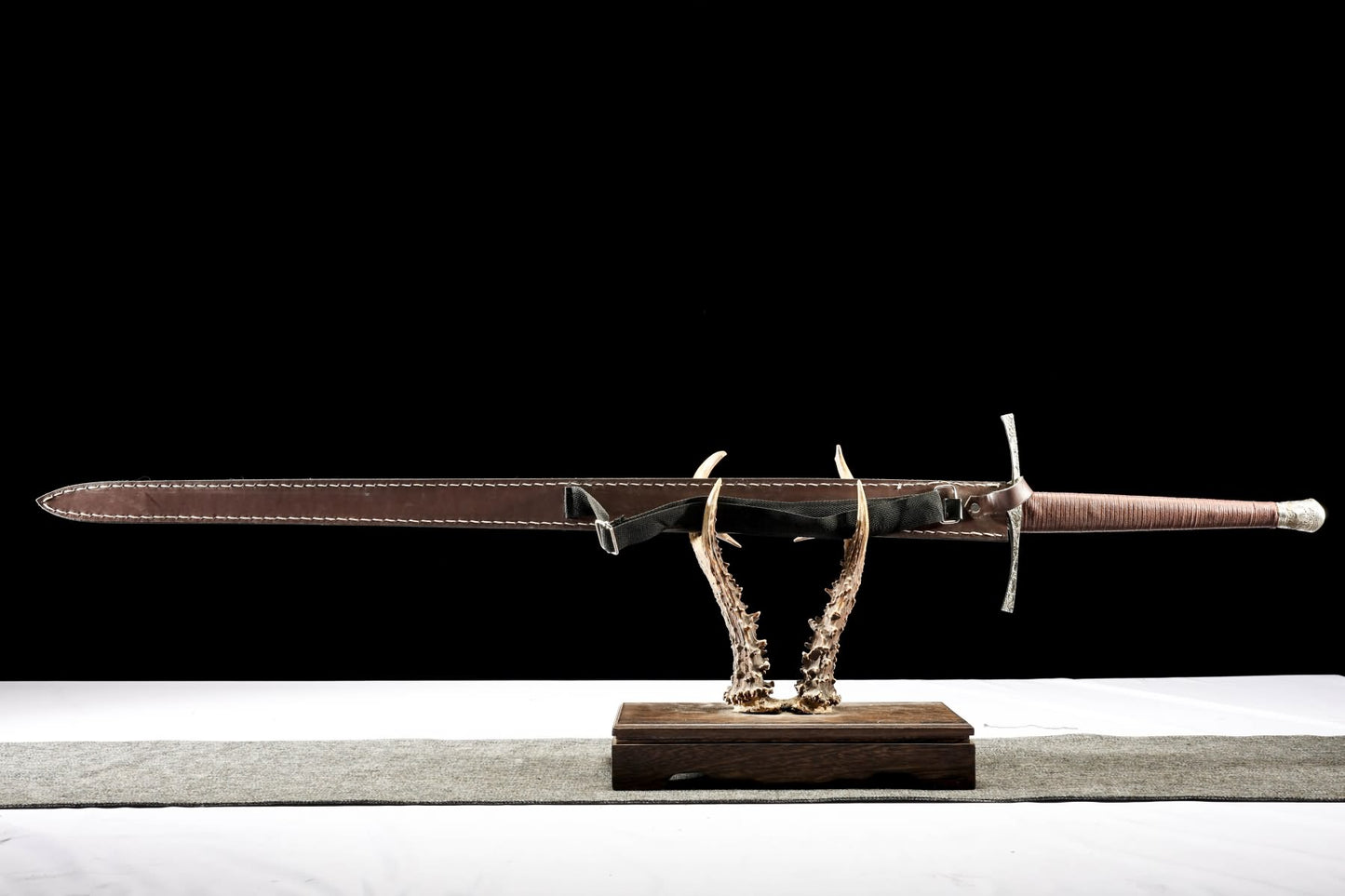Fully sheathed Xiangyun European sword with long wrapped grip and shoulder strap