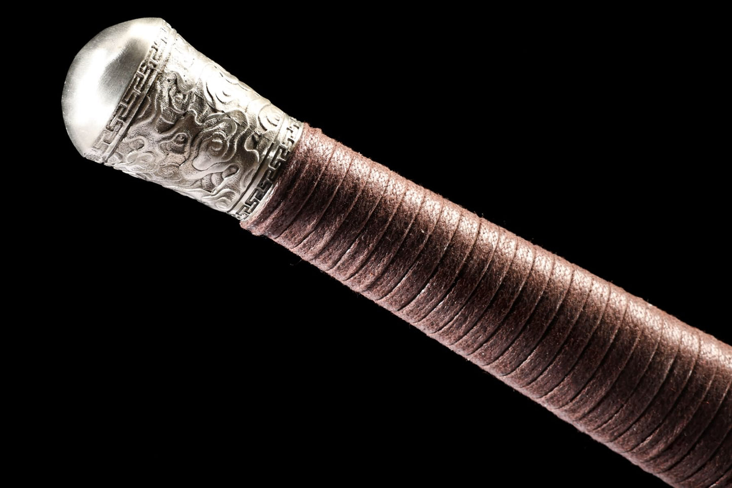 Decorated stainless-steel pommel and brown wrapped grip detail